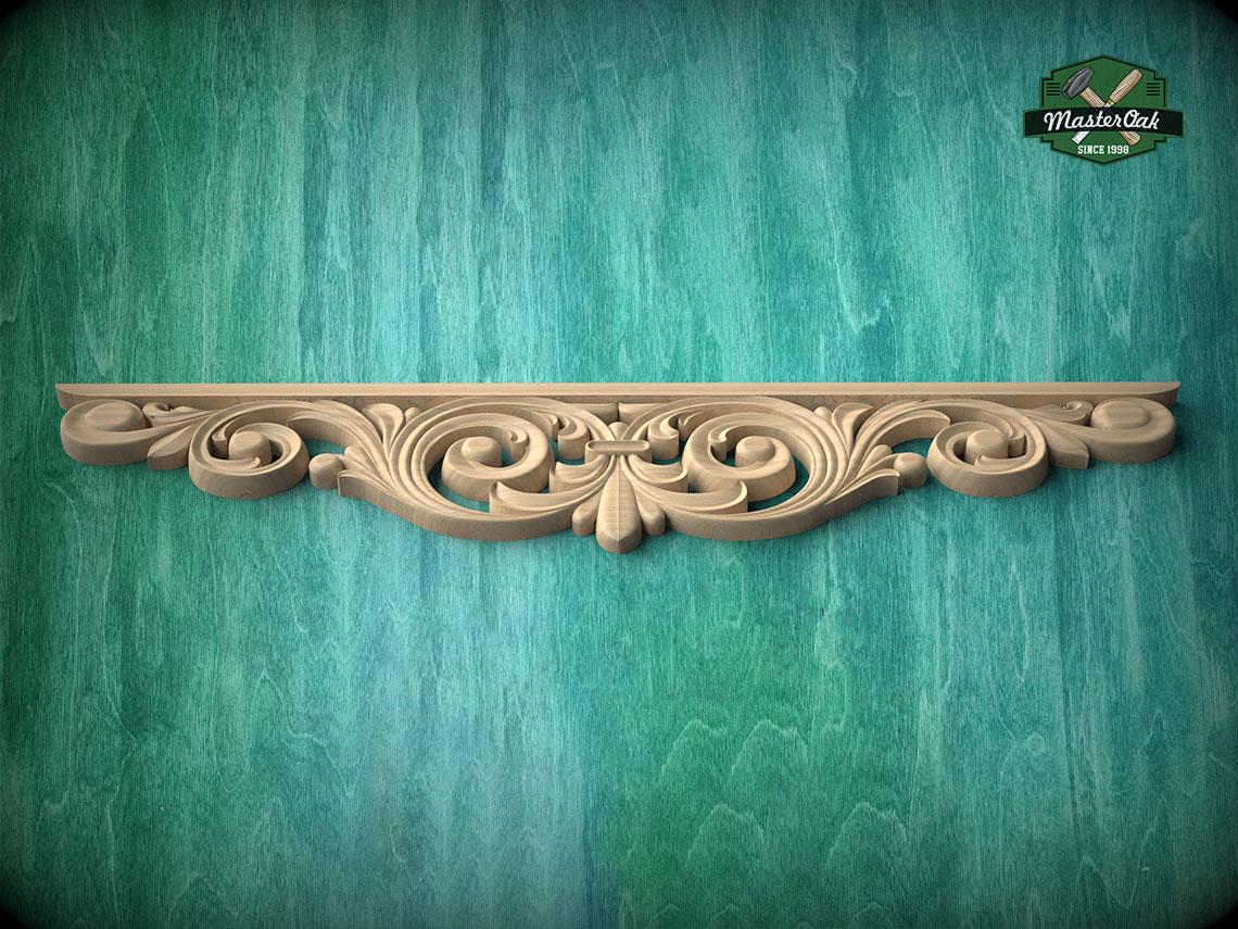 A decorative wooden molding with an intricate scrollwork design is displayed against a green textured background.