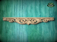 Load image into Gallery viewer, A decorative wooden molding with an intricate scrollwork design is displayed against a green textured background.
