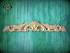 a decorative wooden carving on a green background.