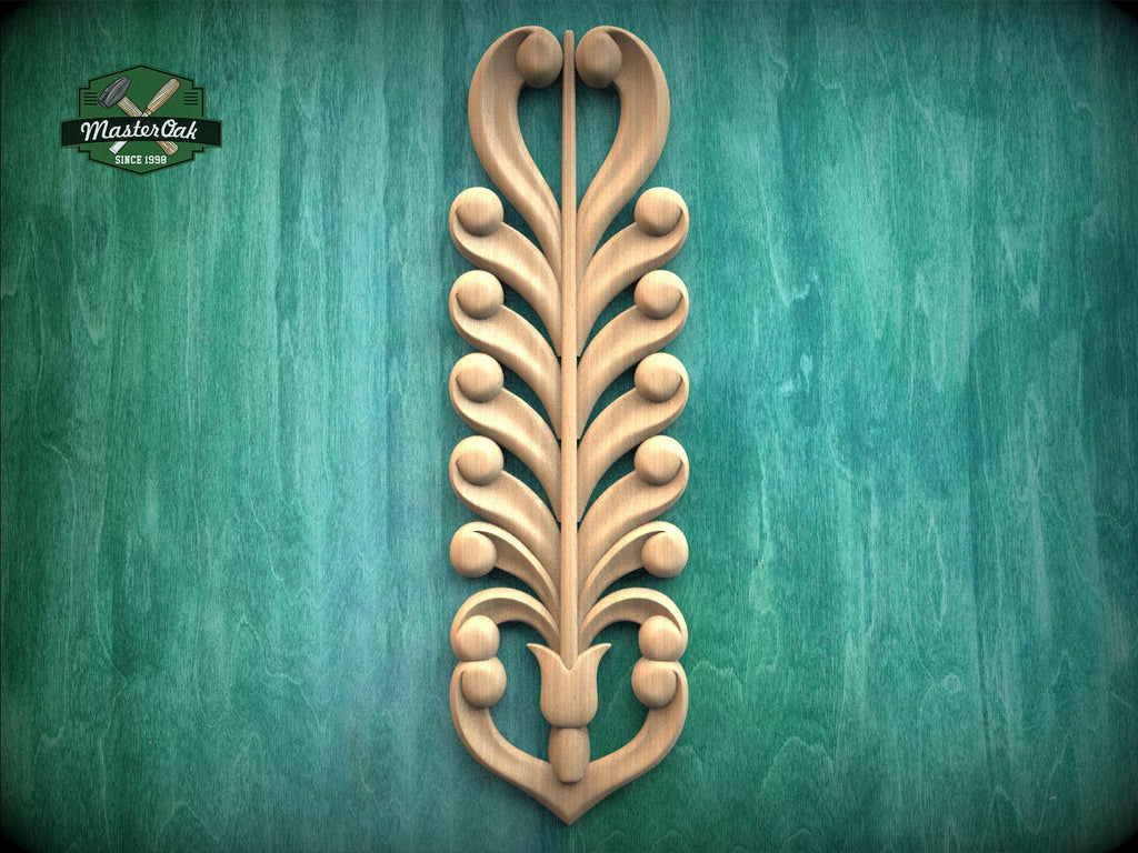 a decorative wooden carving of a stylized tree or plant with intricate scrollwork and shapes, mounted on a green textured background.