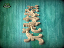 Load image into Gallery viewer, A decorative wooden carving in the shape of a leaf or flower is displayed against a teal-colored background.
