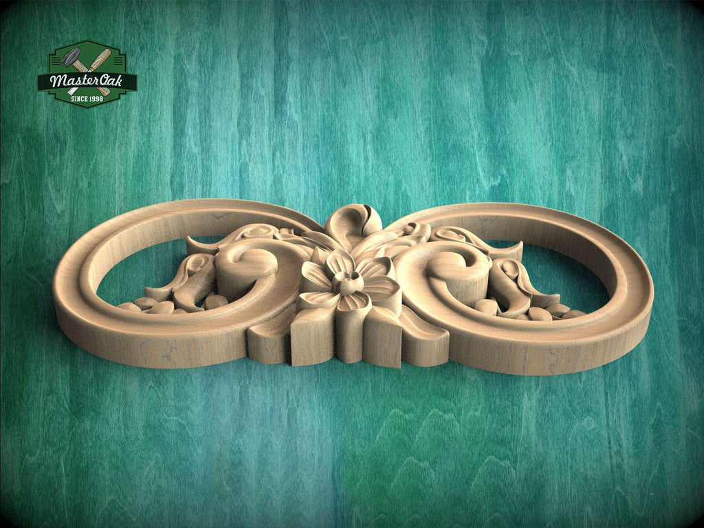 A wooden carving with intricate floral designs on a green background.