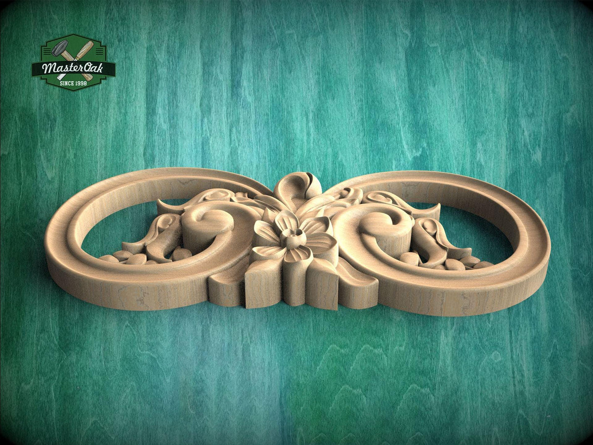 A wooden carving with intricate floral designs on a green background.