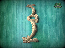 Load image into Gallery viewer, A wooden dragon sculpture is displayed against a teal background.
