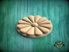 A wooden flower-shaped object is centered against a green background.