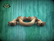 Load image into Gallery viewer, A wooden carving of a stylized flower or plant is displayed against a green textured background.
