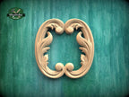 a decorative wooden frame with an ornate, scroll-like design on a green background.