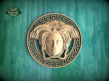Load image into Gallery viewer, a wooden carving of a woman&#39;s face with an ornate design around it, set against a green background.
