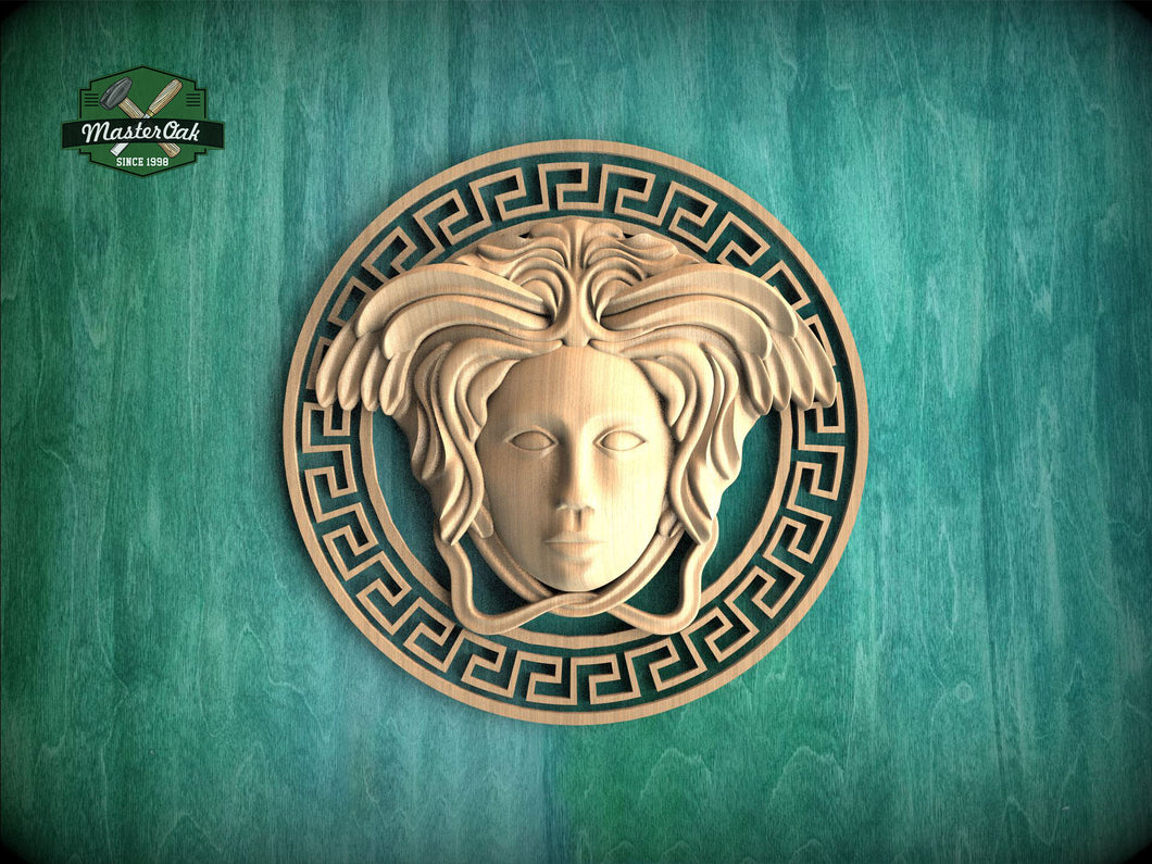 a wooden carving of a woman's face with an ornate design around it, set against a green background.