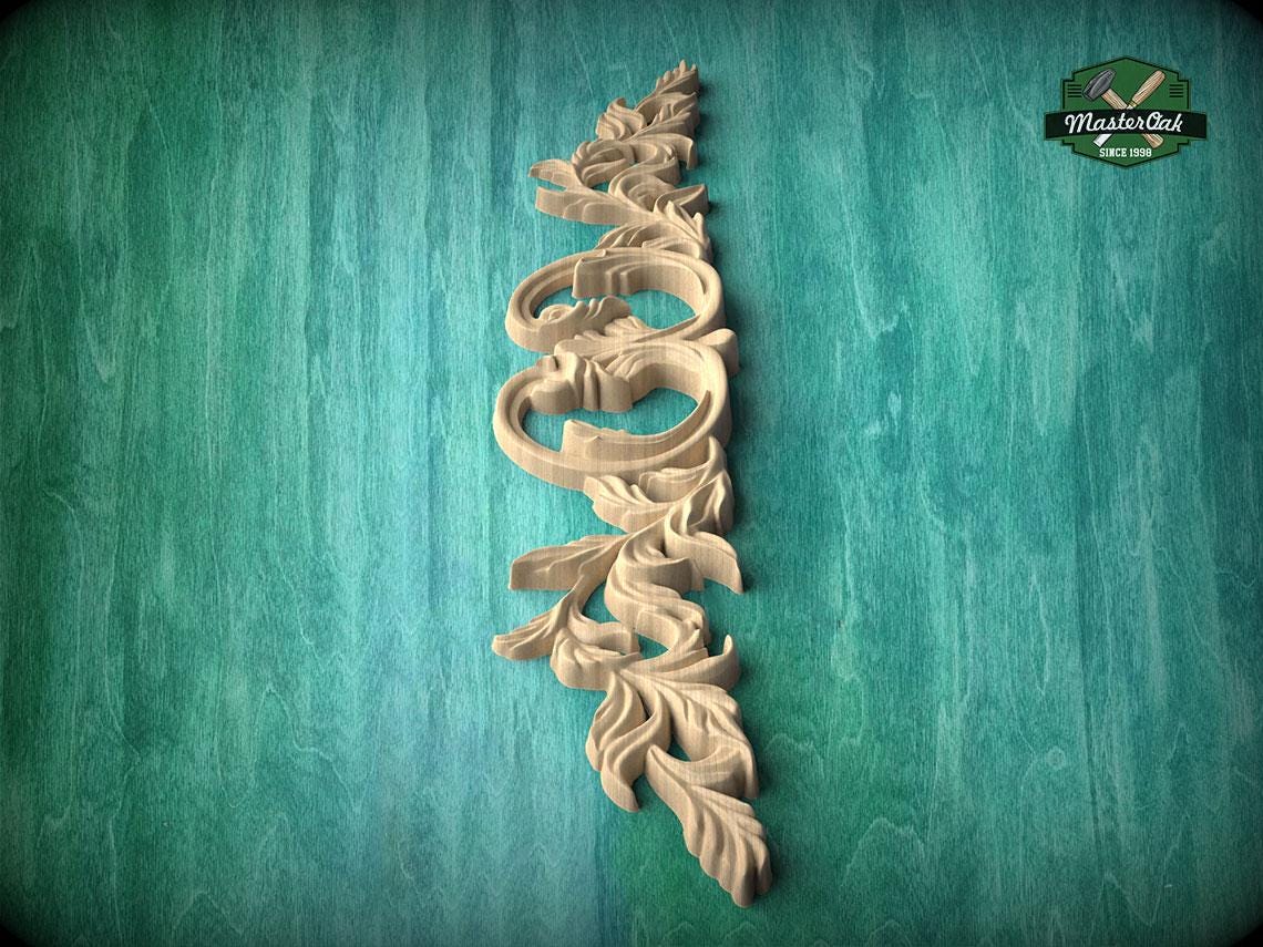 A decorative wooden carving in the shape of a leaf or branch is displayed against a green background.