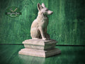 Wood carved fox newel post finial sculpture, natural wood animal statue sitting on a decorative pedestal, displayed on a green wood background