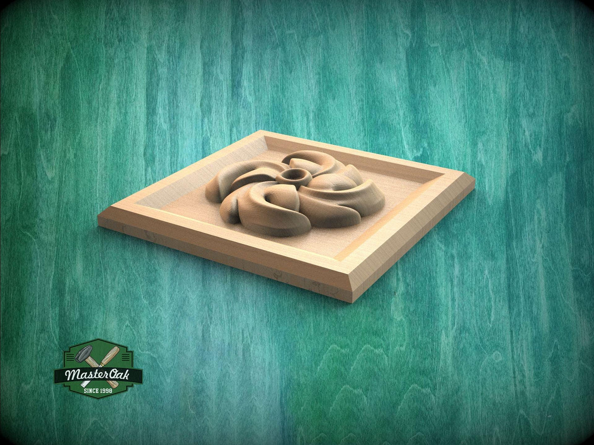 A wooden carving of a flower-like shape is displayed on a wooden surface against a green background.