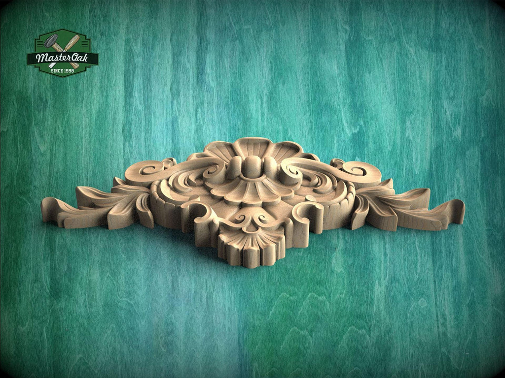 A decorative wooden carving with intricate floral and scrollwork designs is displayed against a green textured background.
