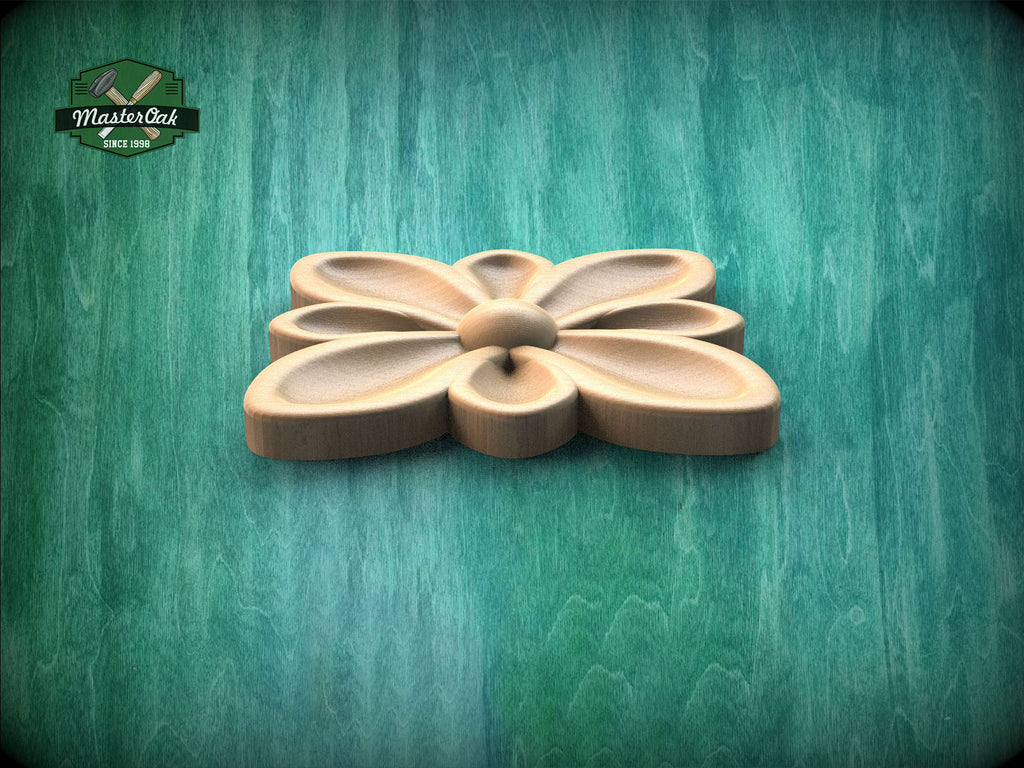 A wooden flower-shaped object is displayed against a green background.